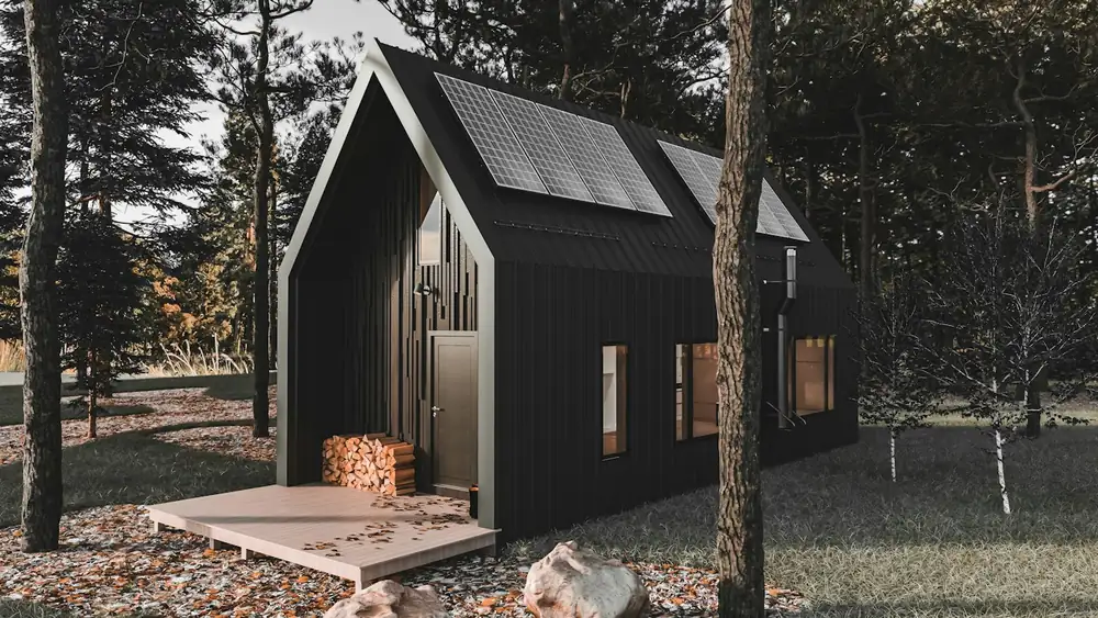 A small modern black cabin among trees