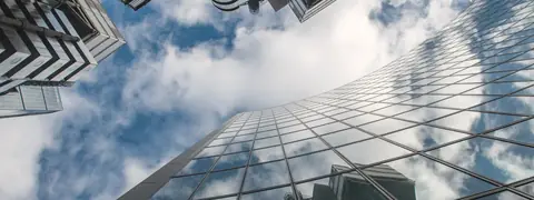 Looking up at a glass office tower