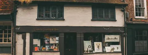 A row of shopfronts along a brick street
